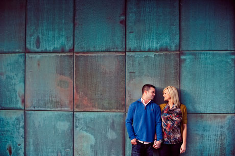 couple in front of green building