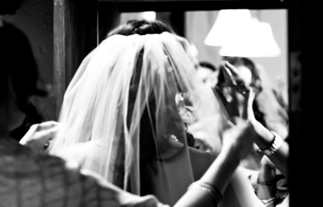 bride putting her dress on at wedding