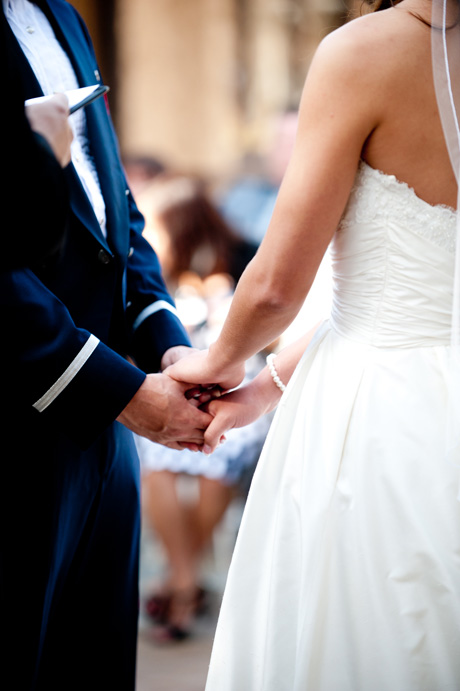 bride and groom holding hands at wedding